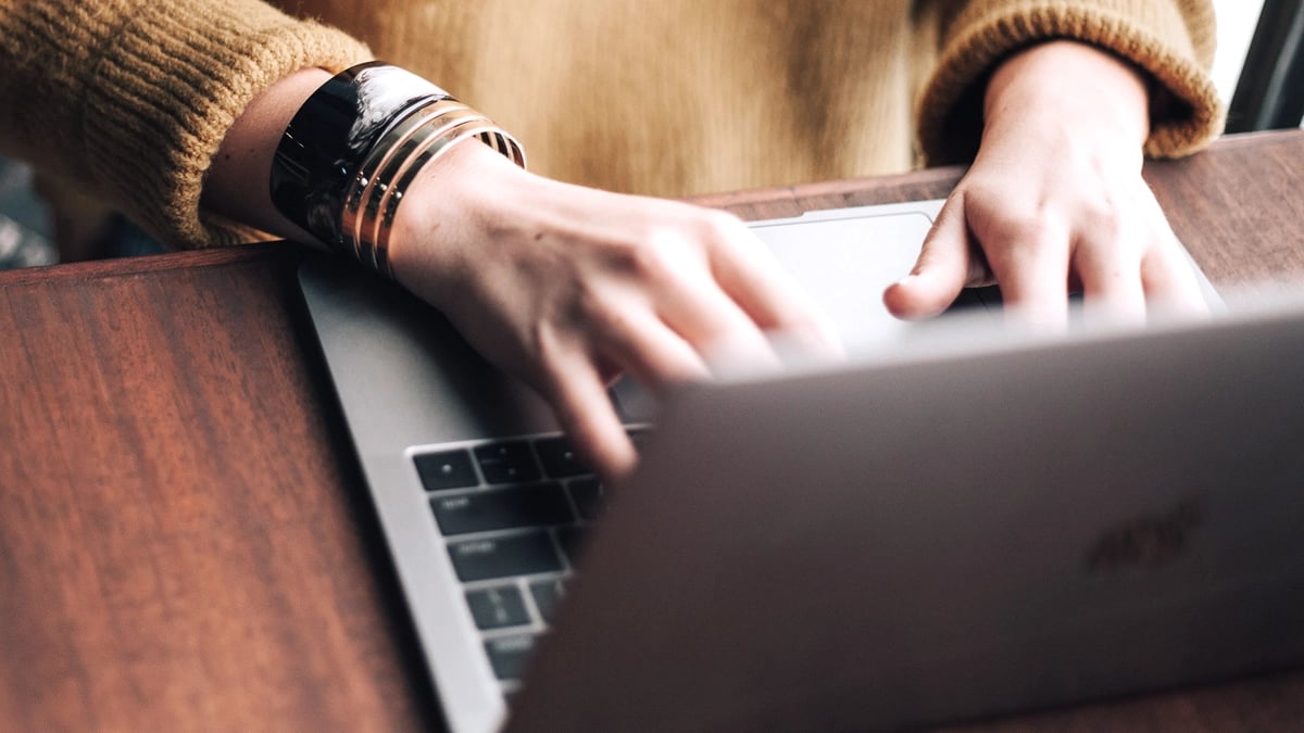 A close up of a person using a laptop.